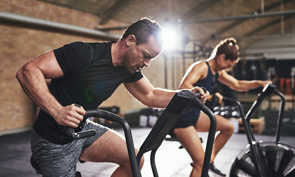 gym Man and woman using exercise equipment at a gym